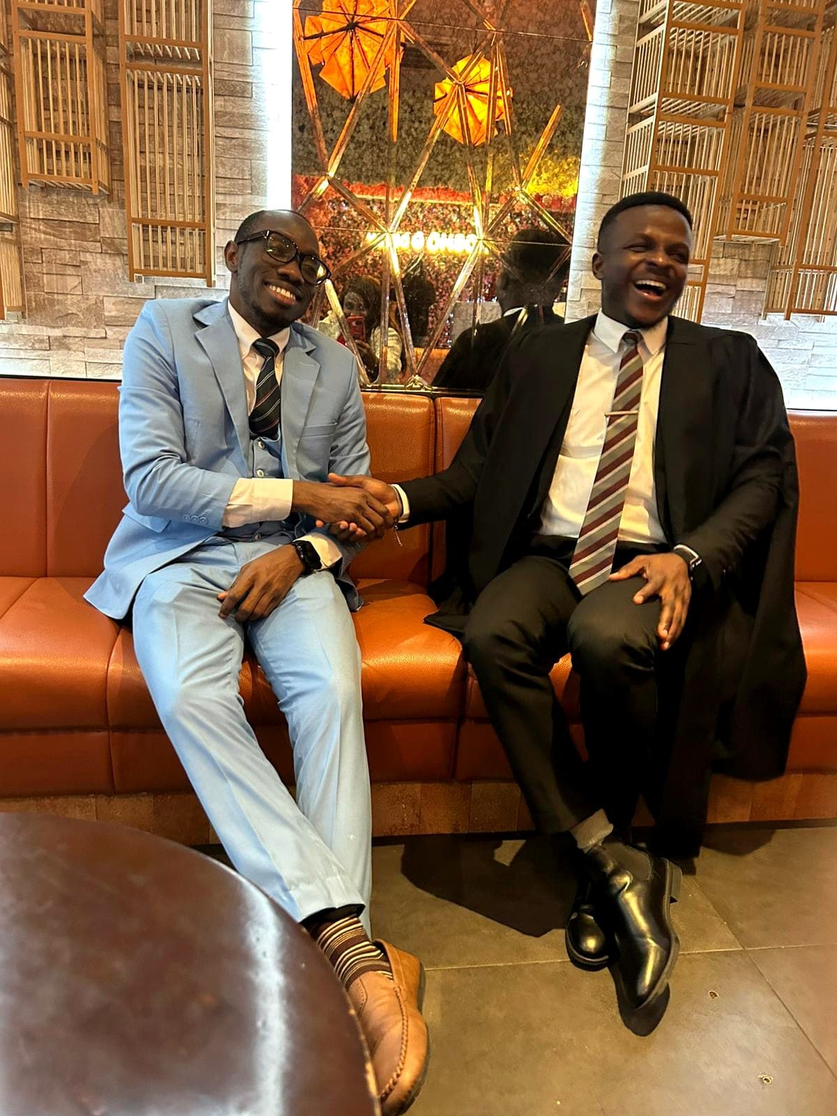 Sam Oluwadare sharing a warm moment with a friend